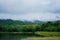 Beautiful scenery of cloud and foggy overcast greenery rain forest mountain with lake landscape at Jedkod-