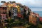 Beautiful scenery of Corniglia, an amazing village of colorful houses perched on a rocky cliff on a sunny summer day
