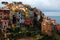 Beautiful scenery of Corniglia, an amazing village of colorful houses perched on a rocky cliff on a sunny summer day in Cinque