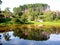 Beautiful scenery with a country house in the middle of the vegetation in front of a lake