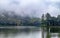 Beautiful scenery of huge lake, with trees, and mist create calming atmosphere