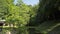 Beautiful scenery landscape over the weir under sunlight in the morning. Panning shot of the park in tropical rain forest.