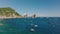 Beautiful scenery of Mediterranean sea coast. Boats moored at shore. Big rocks rising from water in background. Capri