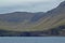 Beautiful scenery of Mulafossur Waterfall Goose valley and Gasadalur village view from water. Vagar island Faroe is