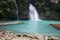 Beautiful scenery of a powerfull waterfall flowing in the sea in Cebu, Philippines