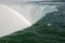 Beautiful scenery of a rainbow forming on the Horseshoe Falls in  Canada