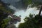 Beautiful scenery of rainbow at Iguacu Iguazu falls bridge with people close to waterfall border of Brazil and Argentina