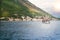 Beautiful scenery with sea and mountains, tourist boat. Fjord in Adriatic Sea. Perast - town on Boka Kotor bay shore, Montenegro.