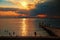 Beautiful scenery of the sea at sunset with a wave on the shore of dramatic clouds and the rays of the sun