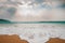 Beautiful scenery of sea waves on the beach under the cloudy sky in Kenting, Taiwan