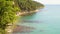 Beautiful scenery of the treed cliff beside the azure waters of the black sea in the daytime under the sunshine. Tuapse, Russia.