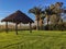 Beautiful scenery of a wooden stand with a roof in a field with exotic