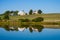 Beautiful scenic barn reflects in mirror like pond