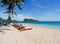 Beautiful scenic chairs on white sand beach near coconut trees with blue sea and sky on island