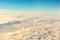 Beautiful scenic dramatic morning sunrise cloudscape aerial view from plane window. Gradient colored fluffy clouds during aircraft