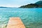 Beautiful scenic landscape with a boat in the bay and a wooden pier near Nydri, Lefkada, Greece. Stunning amazing charming places