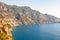 Beautiful scenic landscape of Positano. Rocky coastline full of boats and yachts traveling near high mountains. Cityscape of