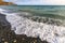 Beautiful scenic landscape of stony beach at Black Sea coast by Anapa, Russia. Wave splashing on the shore making spindrift.