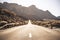 Beautiful and scenic long way road with focus on foreground - defocused background and travel destination effect with sunilght and