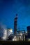 Beautiful scenic of petrochemical oil refinery plant shines with red and white lights at night with and copy space vertical