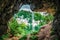 Beautiful scenic summer landscape of Kurdzhips gorge viewed from inside rocky grotto with waterfall in Caucasus mountains by