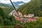 Beautiful scenic townscape of Rosa Khutor mountain ski resort surrounded with green summer Caucasus mountain forest and Aibga