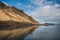 beautiful scenic view of rocky hills reflected in water,