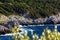 Beautiful scenic view of sea waves crashing onto rocks with water splashes. Gialova, Peloponnese, Greece