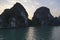 Beautiful scenic view of two large rock formations at sunrise, Halong Bay, Vietnam