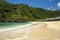 Beautiful scenic view of umbrellas in line in front of turquoise sea water at Atuh beach tropical paradise of Bali island in