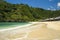 Beautiful scenic view of umbrellas in line in front of turquoise sea water at Atuh beach tropical paradise of Bali island in