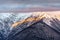 Beautiful scenic winter sunset mountain landscape of Main Caucasus ridge with snowy mountain peaks covered with clouds, Sochi, Rus