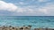 Beautiful sea and cloud landscape. Caribbean sea coast with turquoise water and stony beach