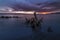 Beautiful sea landscape. Bright golden sunset with dramatics clouds over the lake after rain.