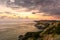 Beautiful sea sunset and rocky coast. Dramatic sky with clouds.