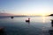 Beautiful sea sunset with with silhouettes of boats and inflatable flaming