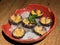 Beautiful sea urchin on a plate. Close up and top view. Wooden table, ice and leaf.