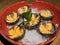 Beautiful sea urchin on a plate. Close up and top view. Wooden table, ice and leaf.