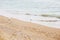 Beautiful seagulls and sea waves foam on sandy beach with seashells on tropical island. Waves and birds in ocean bay or lagoon.