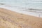 Beautiful seagulls and sea waves foam on sandy beach with seashells on tropical island. Waves and birds in ocean bay or lagoon.