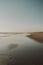 Beautiful seascape of the calm sea and the large coast in the evening