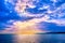 Beautiful seascape with clouds and sun rays cast over sea waters horizon