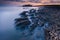 Beautiful seascape with long exposure of rocks and sea at sunset