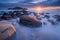 Beautiful seascape with long exposure of rocks and sea at sunset