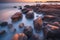 Beautiful seascape with long exposure of rocks and sea at sunset