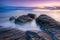 Beautiful seascape with long exposure of rocks and sea at sunset