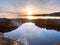 Beautiful seascape. Mirroring of sunset in water pools in the rocks . Smooth ocean