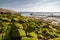 Beautiful seascape of mossy rocks near the Port of Socoa in France on a sunny day