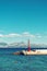 Beautiful seascape, pier with lighthouse against rocky shore and clear blue sky