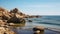 Beautiful seascape with rocks on the beach and blue sky, Big rocks on the ocean landscape beach view with blue sky, AI Generated
